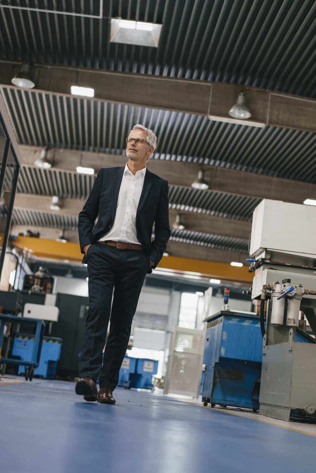 Successful entrepreneur in factory workshop of his company Successful entrepreneur in factory workshop of his company